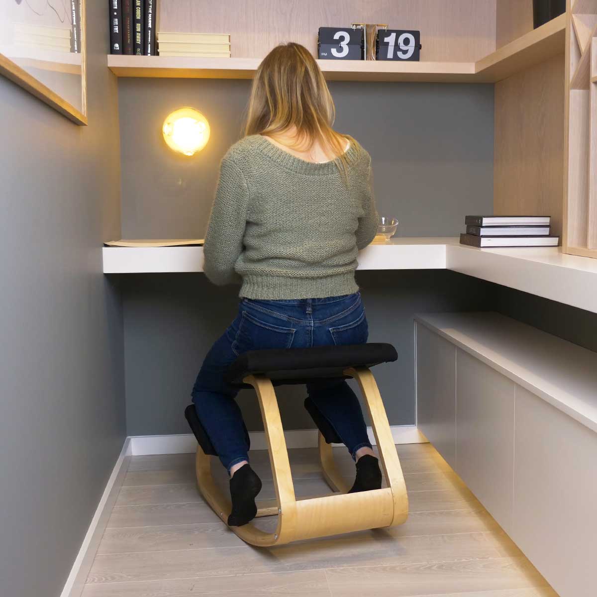 Woman sitting on ergo Kneeling & Rocking Chair at desk